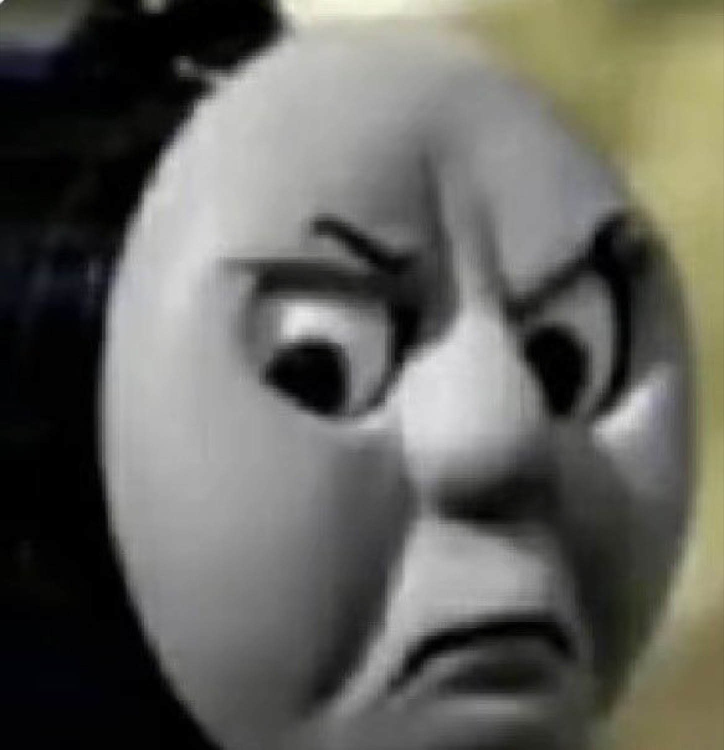 Thomas the Tank Engine scowling with furrowed brows and a hard frown