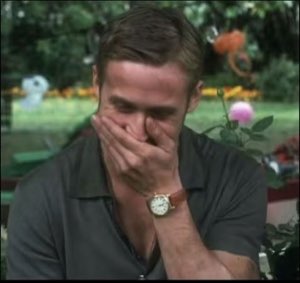 Man covering his face with his hand, cracking up in a sunny garden