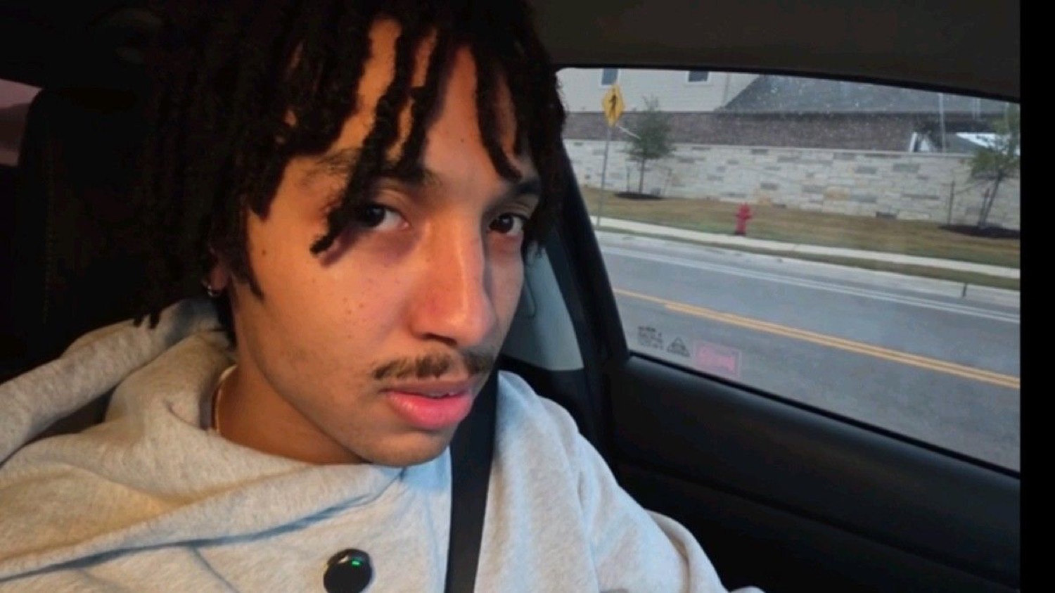 Guy in a car selfie giving the camera a flat, unimpressed look