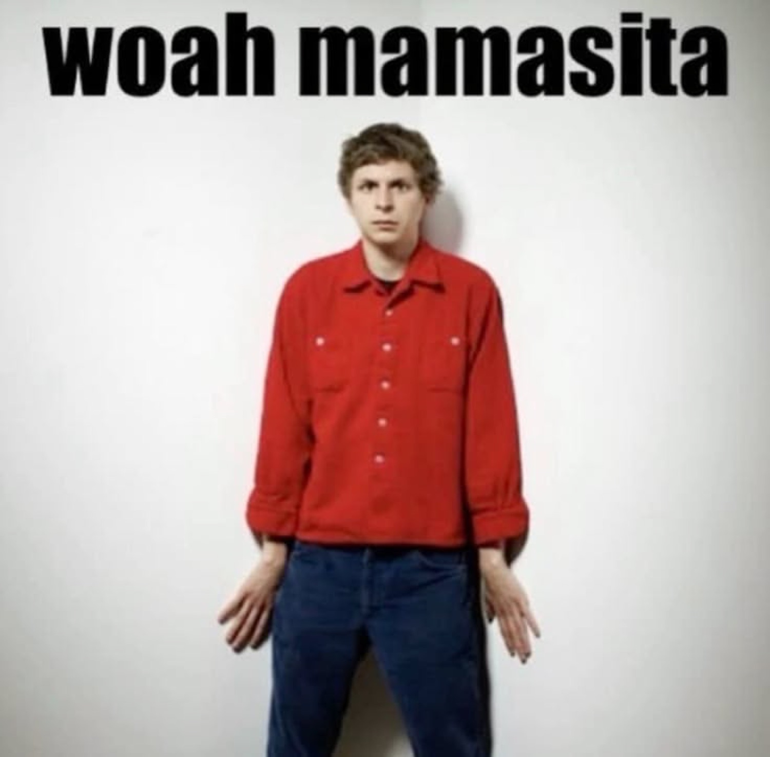 Guy in a red shirt standing stiffly against a wall, captioned 'woah mamasita'