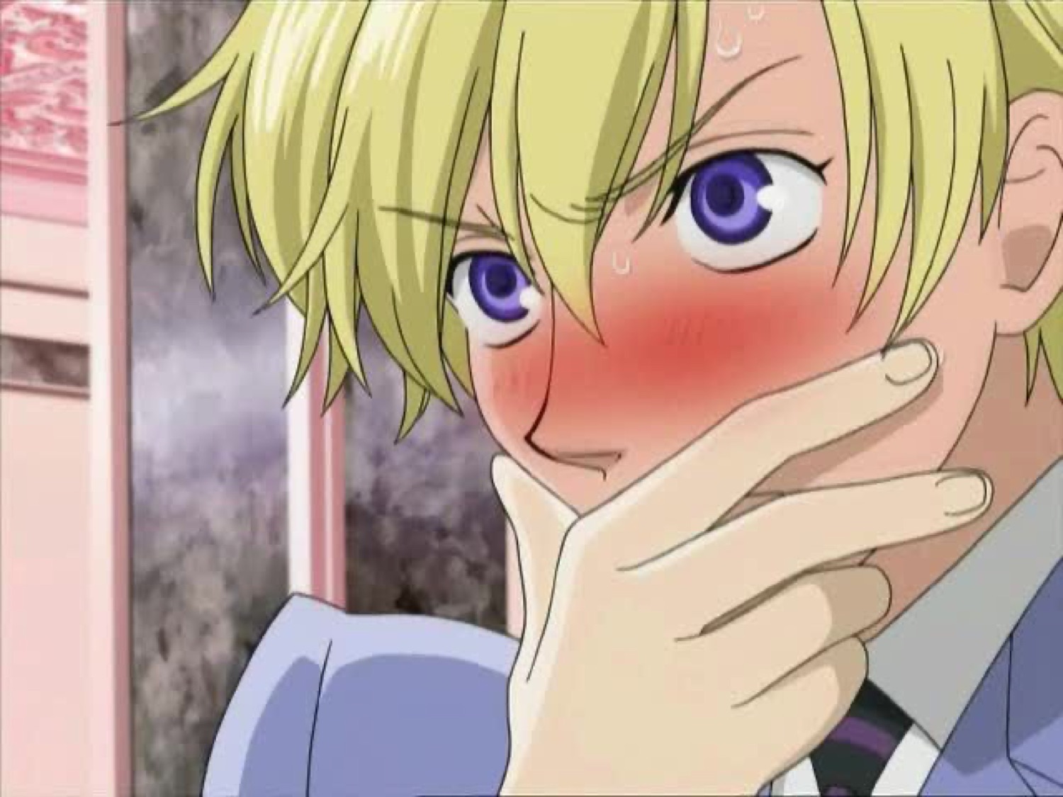 Anime character with blonde hair blushing and covering their mouth in flustered shock