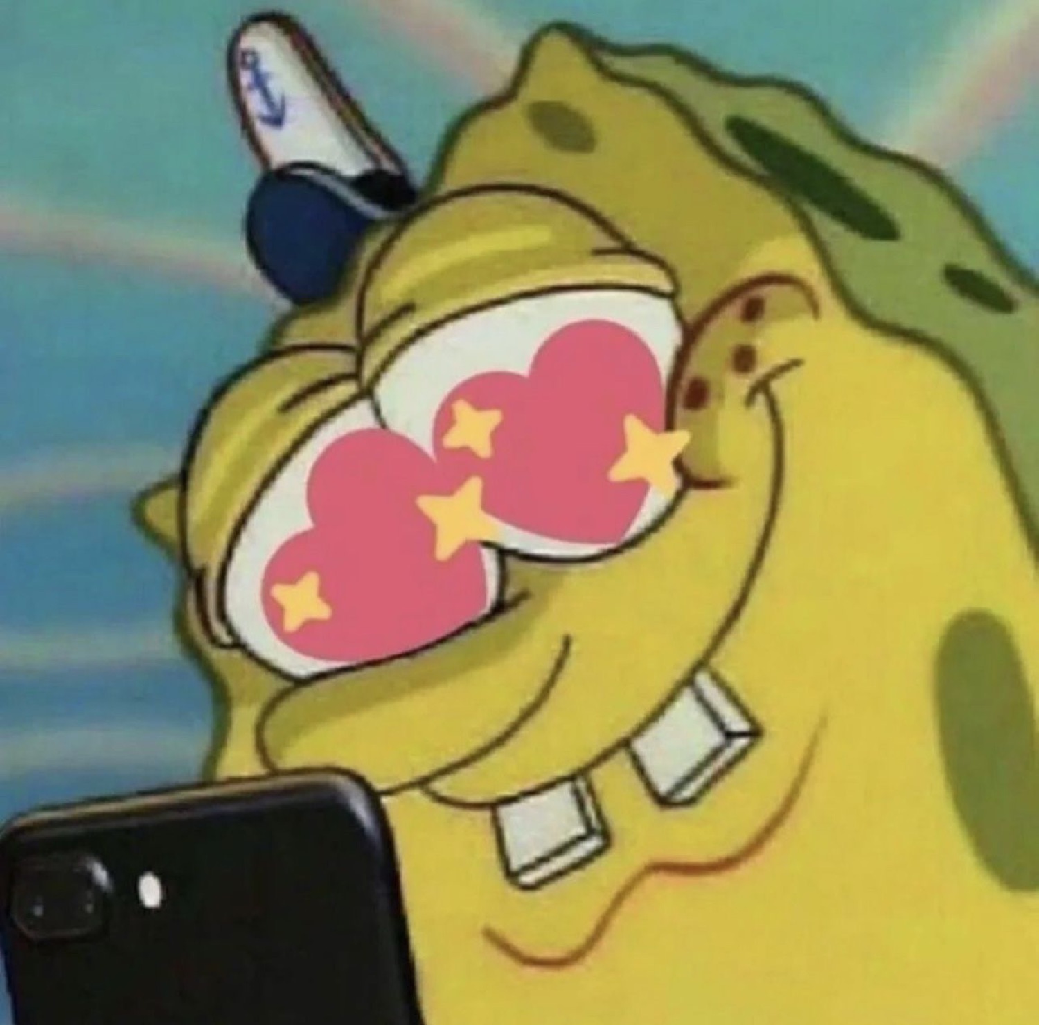 SpongeBob staring at a phone with big pink heart eyes