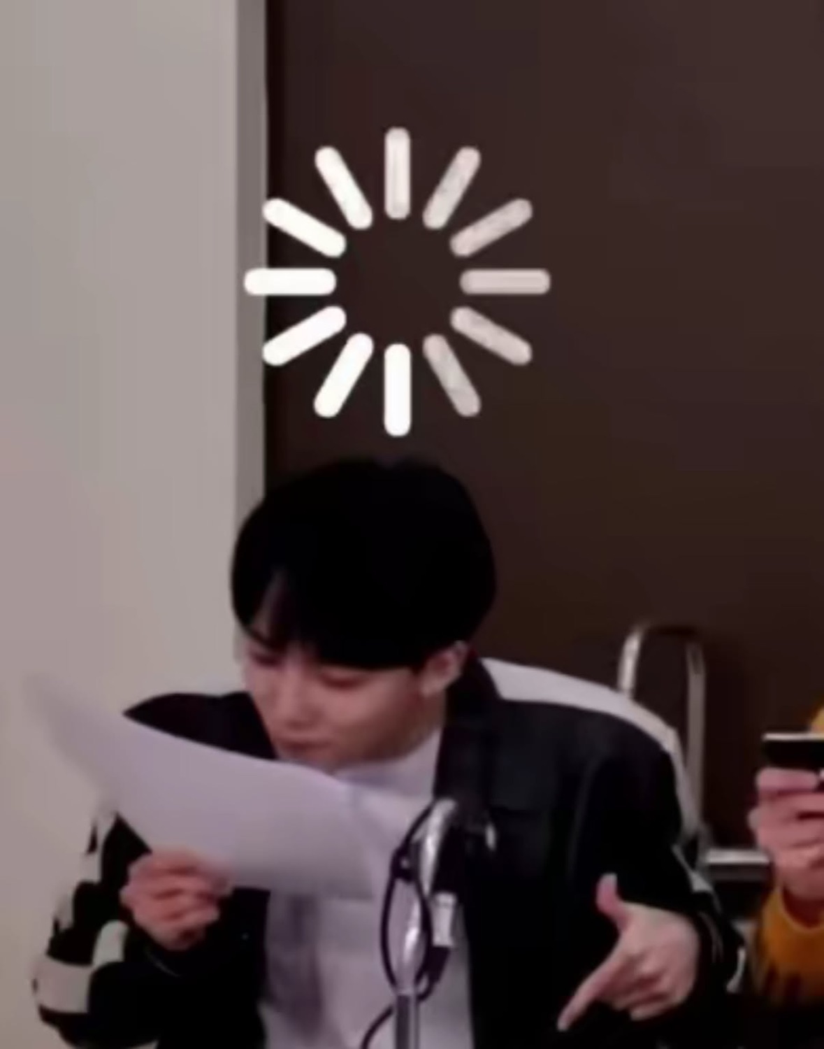 Person reading a paper blankly with a loading spinner graphic over their head