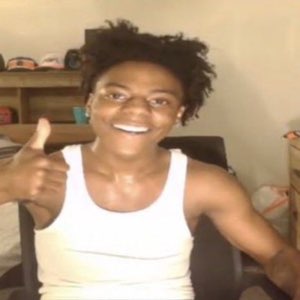 Grinning guy in a white tank top throwing an enthusiastic thumbs up