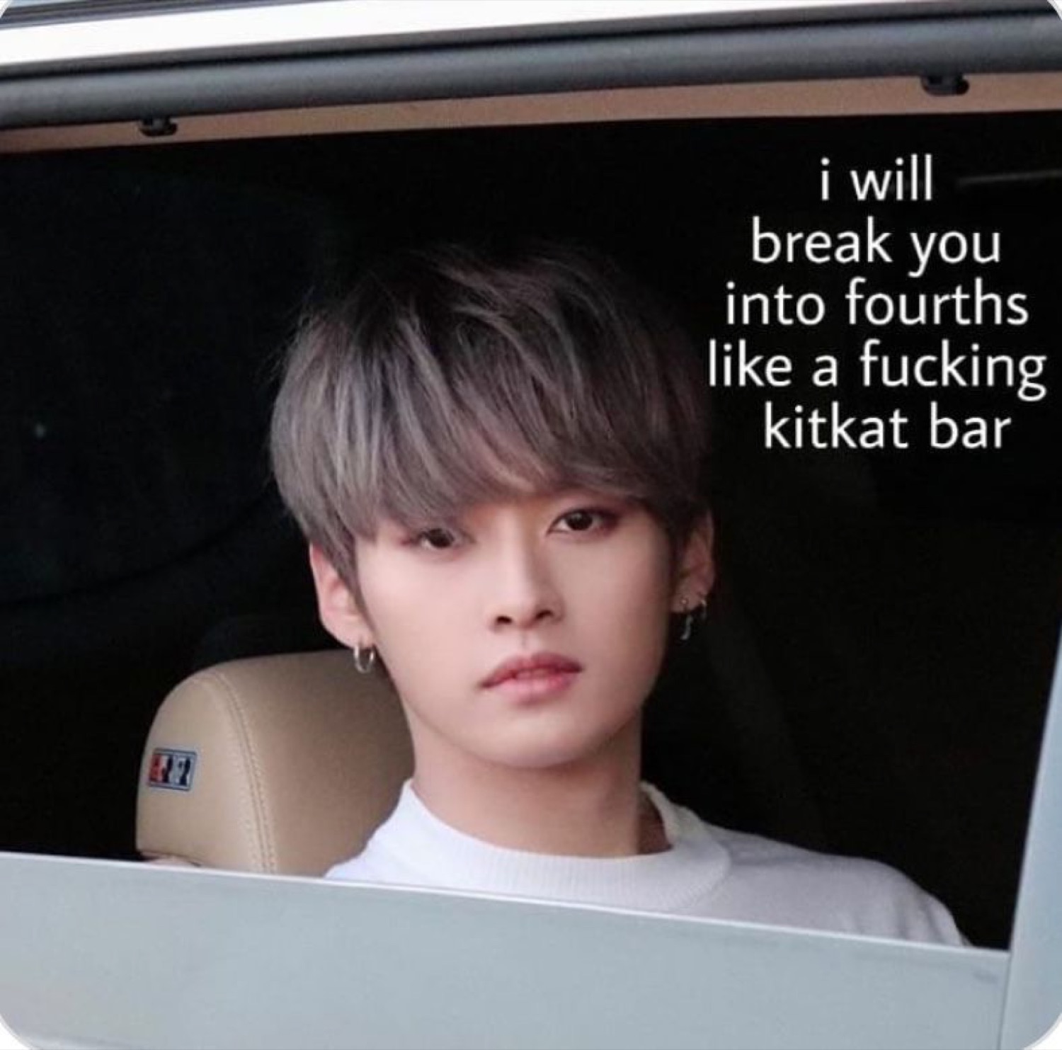 Deadpan man in a car window captioned 'i will break you into fourths like a fucking kitkat bar'