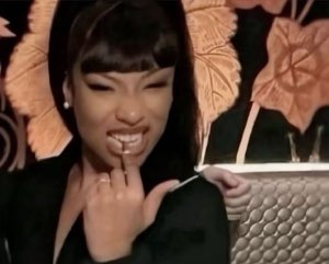 Woman biting her finger with a shy flirty grin