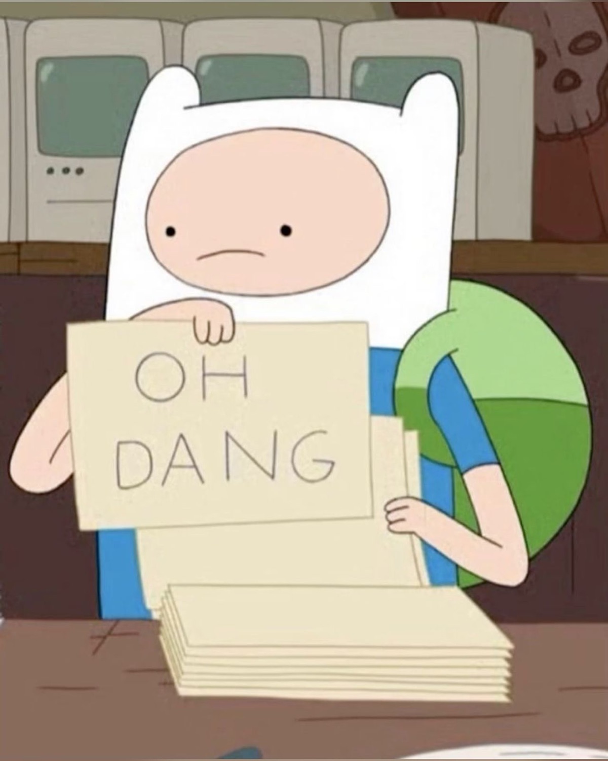 Finn from Adventure Time holding up a card reading 'OH DANG' with a glum face