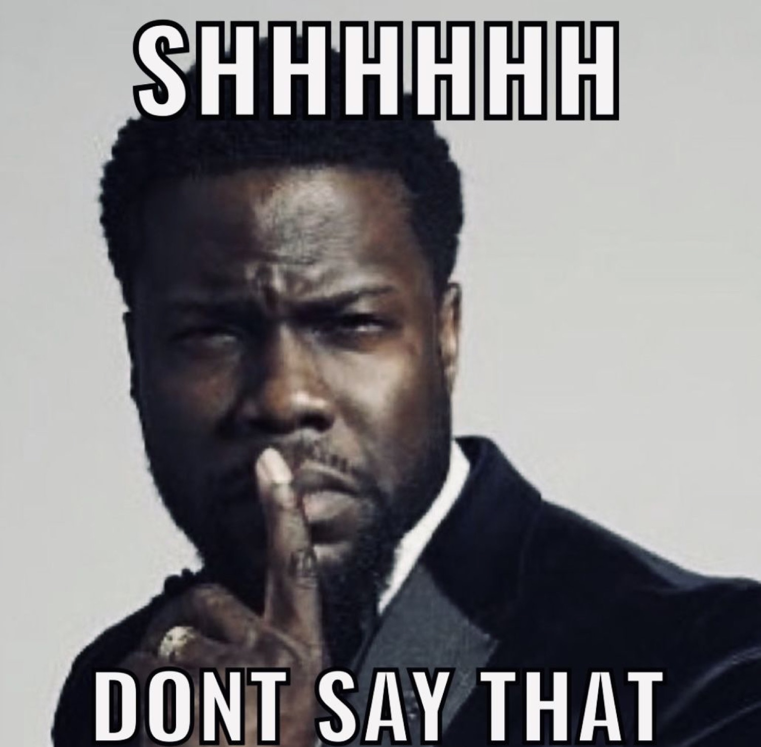 Kevin Hart in a suit putting finger to lips with text 'SHHHHHHHH DONT SAY THAT'