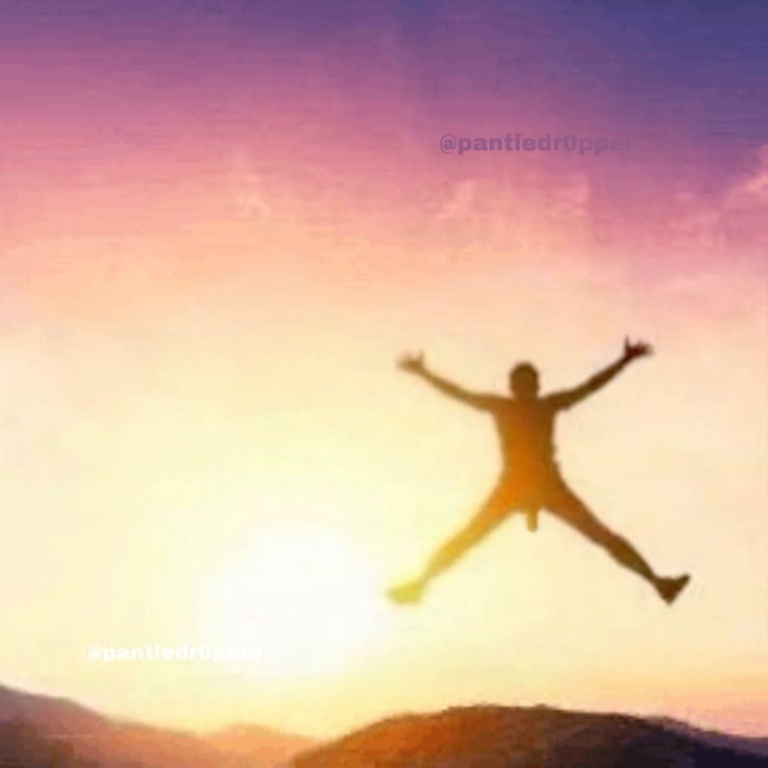 Silhouette of a person leaping with arms wide open against a pink sunset