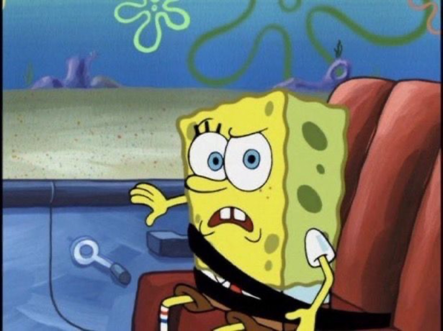SpongeBob slouched in a chair with a confused, irritated frown