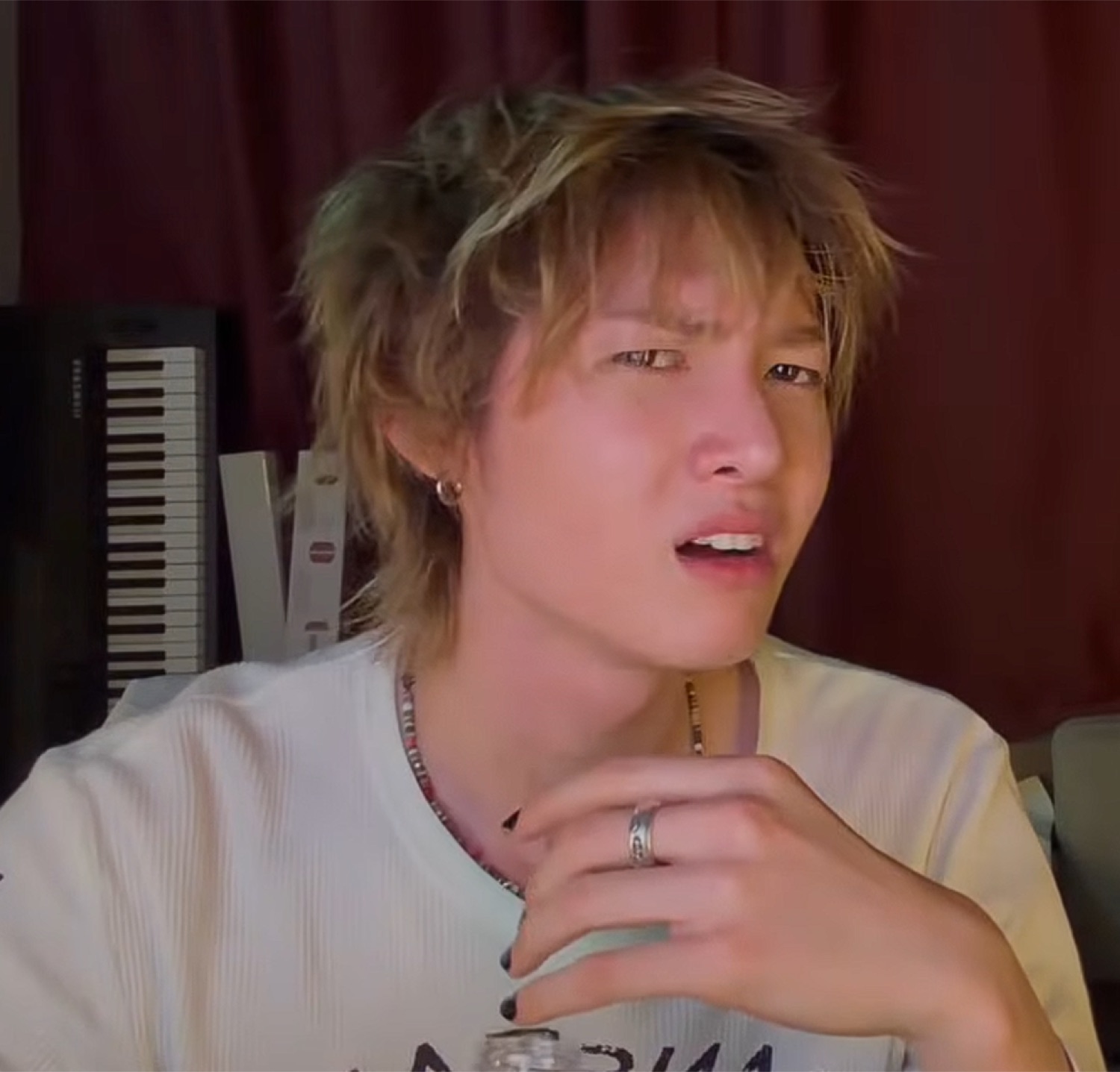 Blond man mid-sentence with furrowed brow looking confused and skeptical