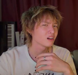Blond man mid-sentence with furrowed brow looking confused and skeptical