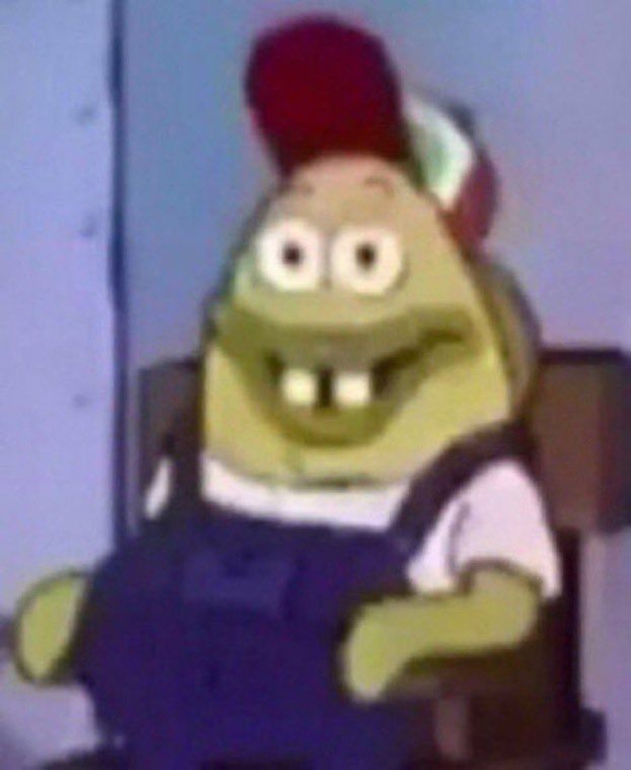 Sponge-like cartoon character with a big goofy grin and gap teeth sitting back relaxed