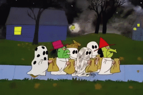 Cartoon kids in ghost costumes trick-or-treating down the street