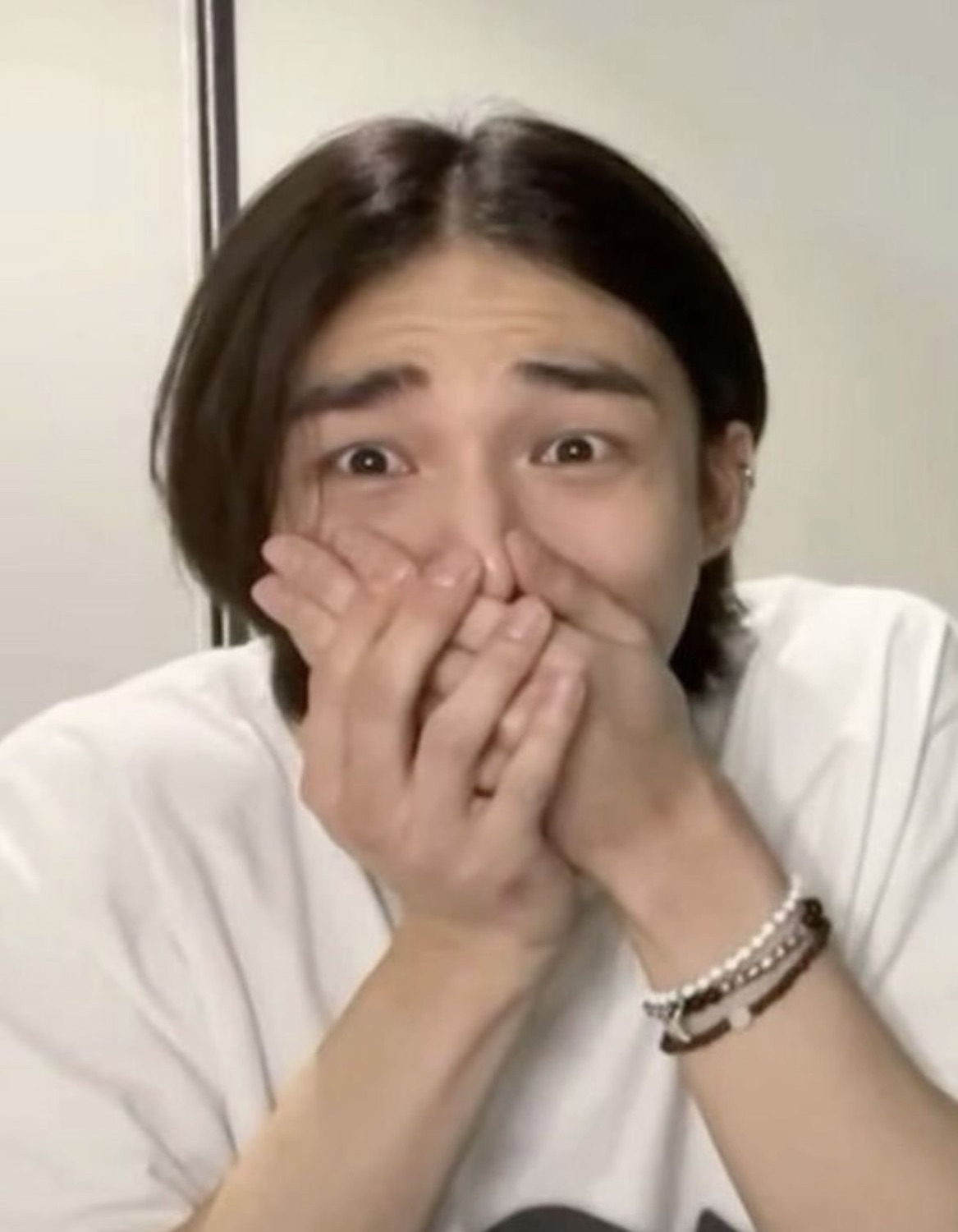 Guy with both hands clapped over his mouth, eyes wide in secondhand horror