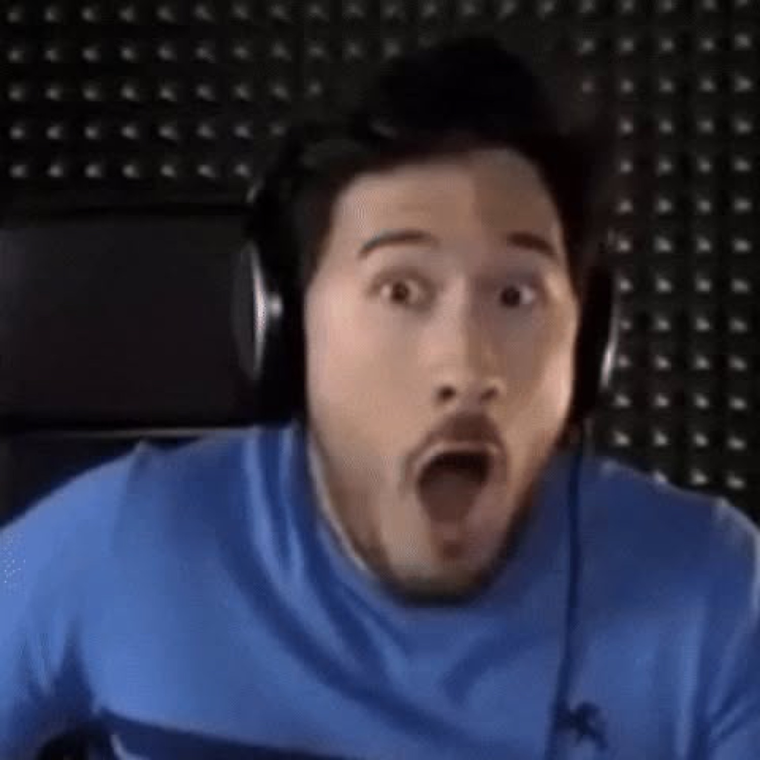 Streamer in headphones with his eyes wide and mouth dropped open