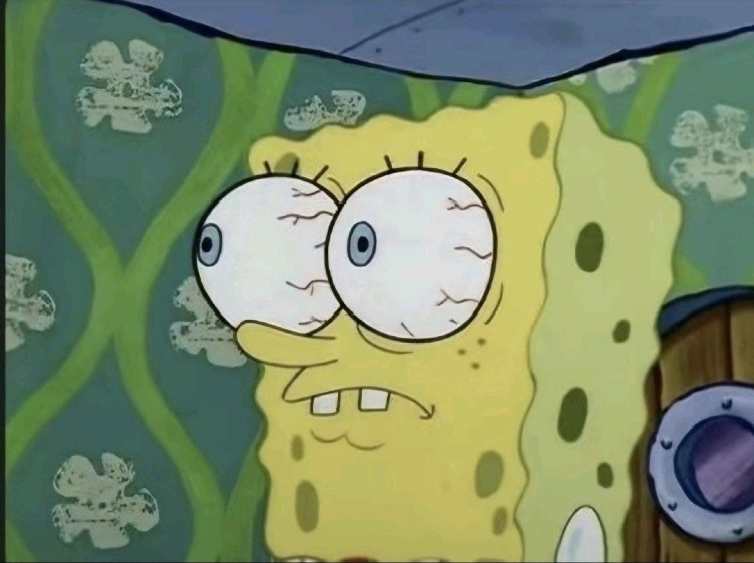 SpongeBob with bloodshot bulging eyes and a grimace, barely holding it together