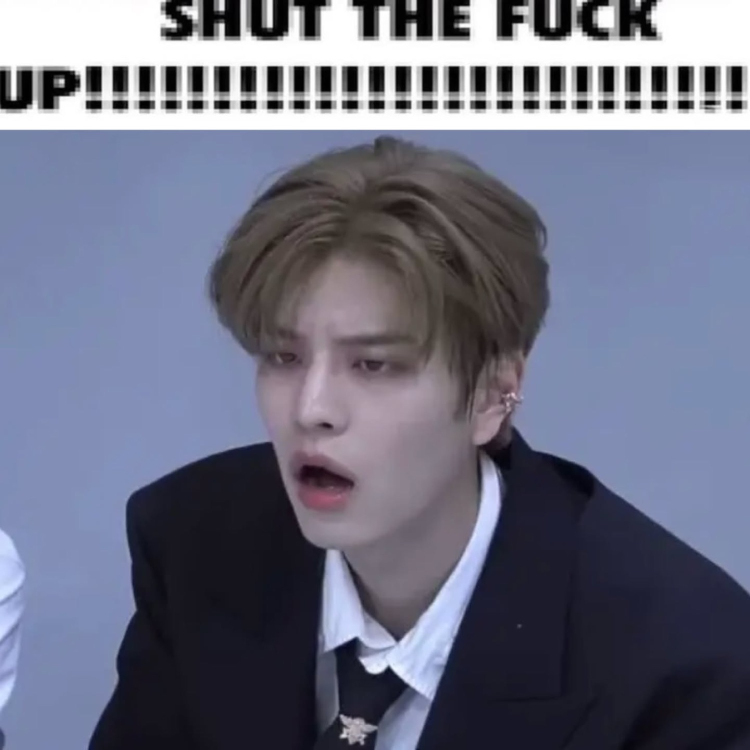 K-pop idol sitting with mouth agape, captioned 'SHUT THE FUCK UP!!!!!!!!!!!!!!!!!!!!!!!!!!'