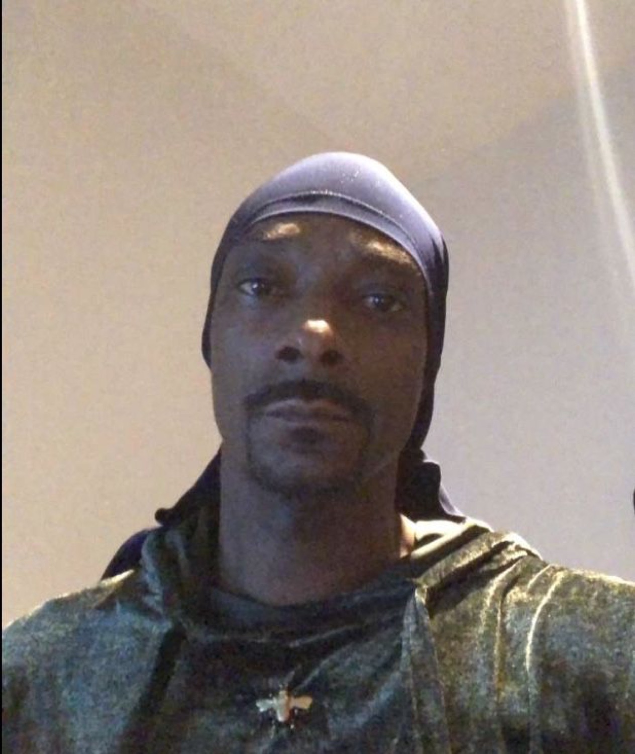 Snoop Dogg in a durag staring flatly into the camera