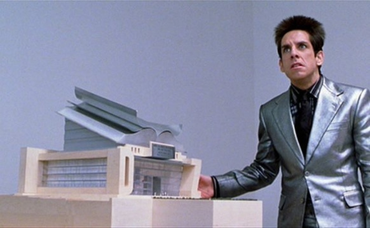 Zoolander squinting in bewildered shock at the tiny model building