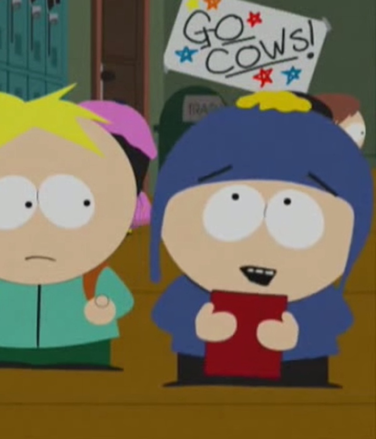Two South Park kids by the lockers, one deadpan under a 'GO COWS!' sign