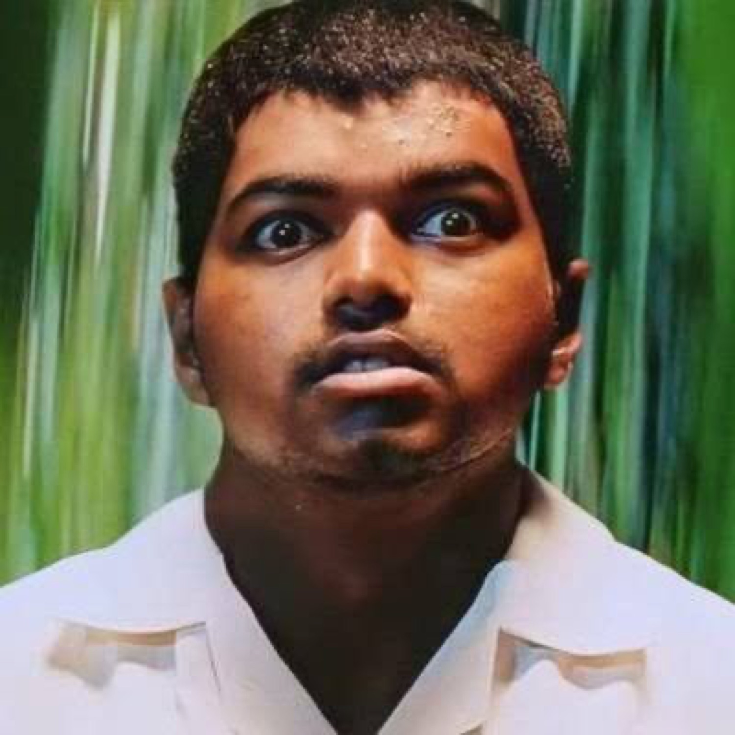 Young Vijay staring with huge startled eyes