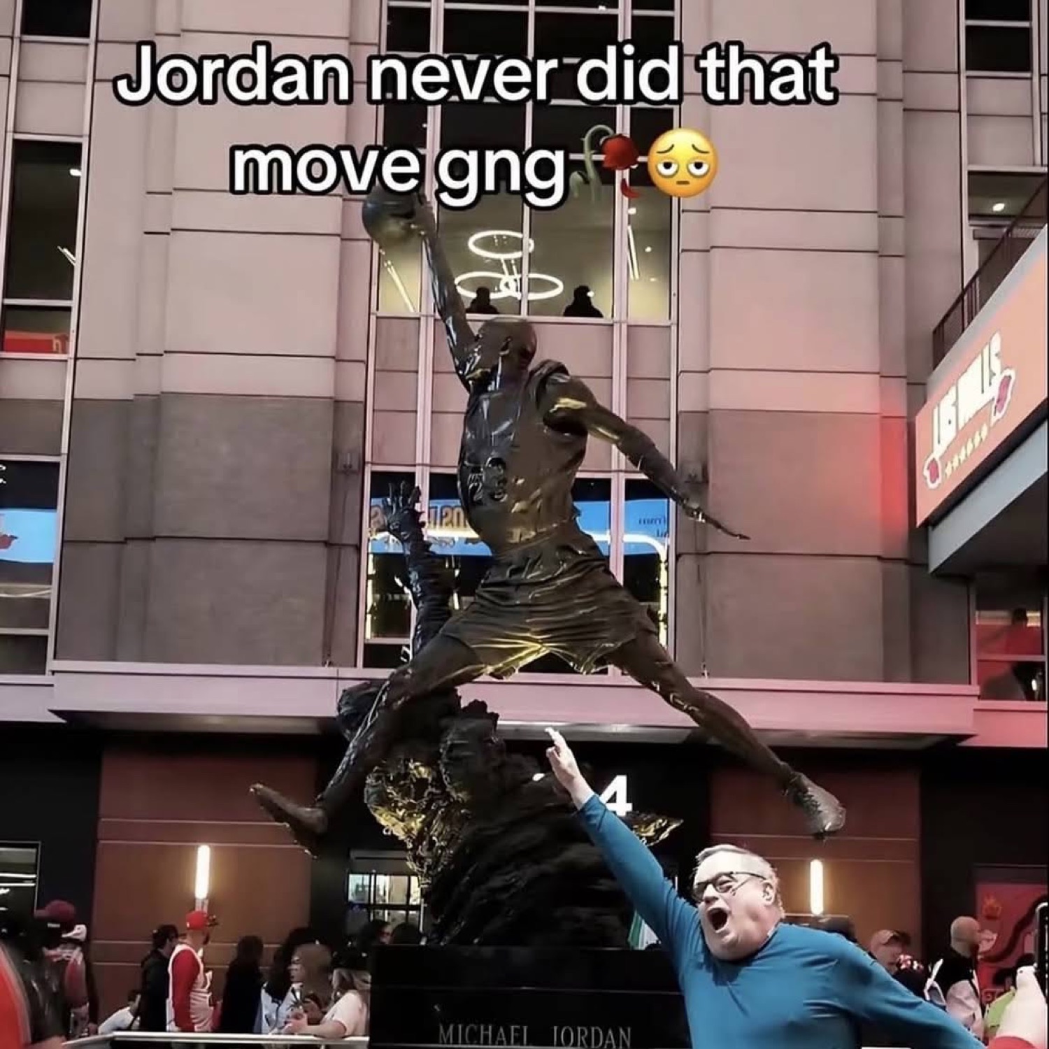 Man pointing up at the Michael Jordan statue under 'Jordan never did that move gng ๐ฅ๐ณ'
