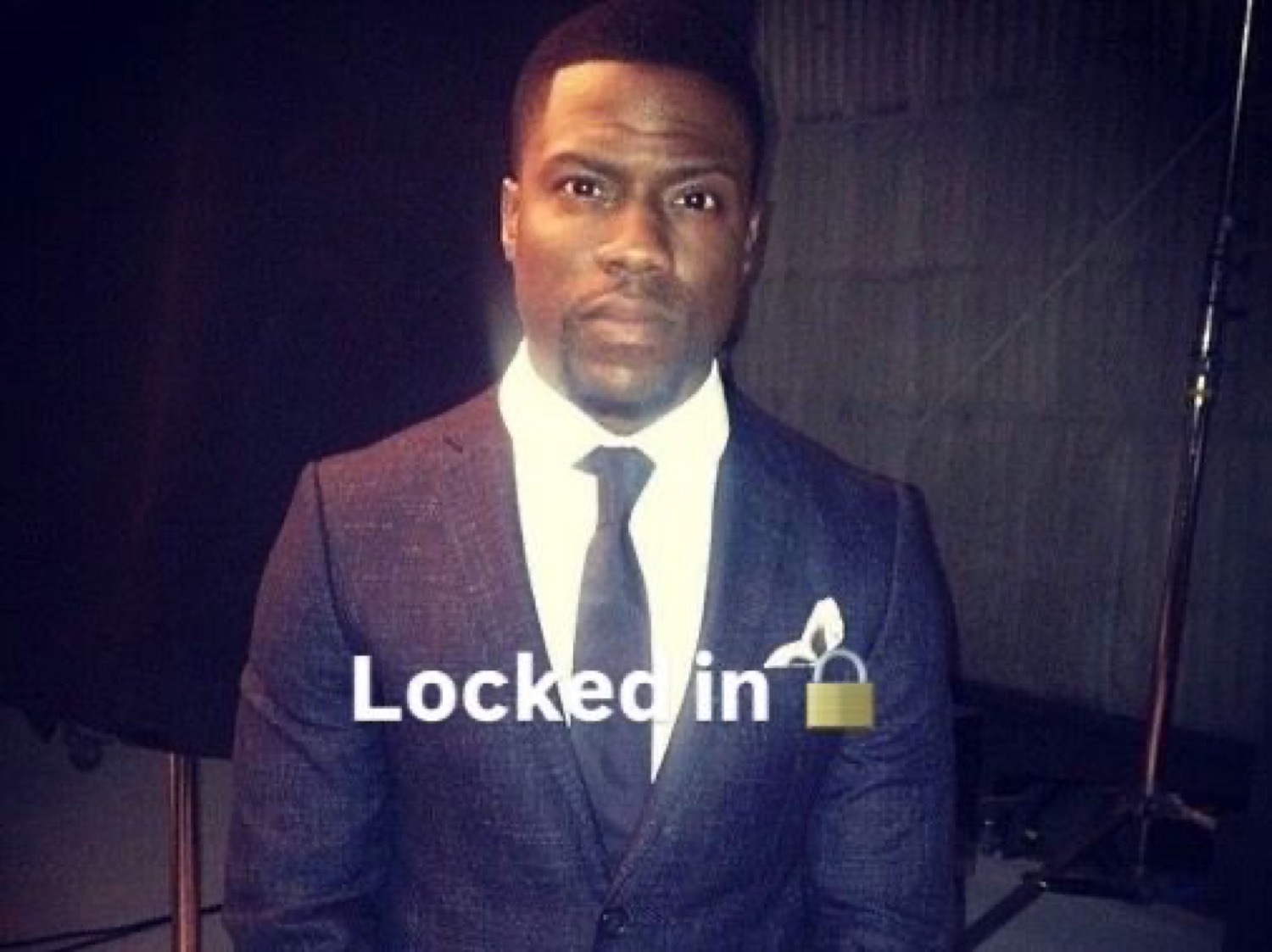 Kevin Hart in a suit staring seriously under 'Locked in 🔐'