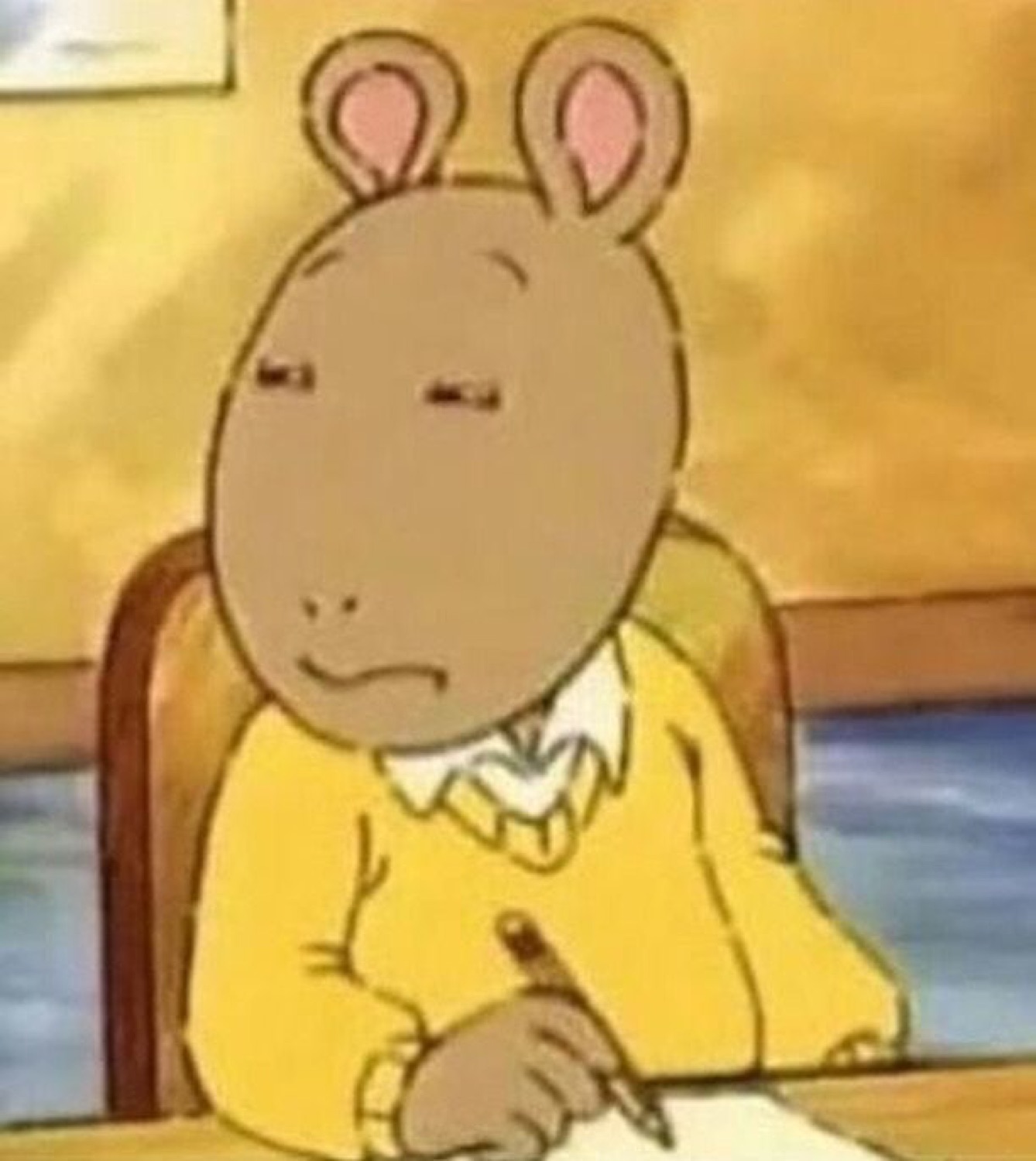 Arthur sitting at a desk with heavy-lidded done eyes and a look of deep resignation