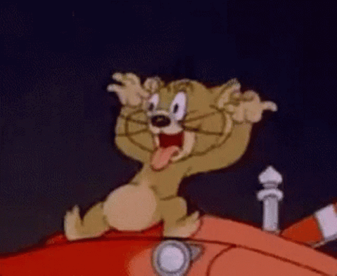 Cartoon mouse on a red car pulling a mocking face with his hands at his ears