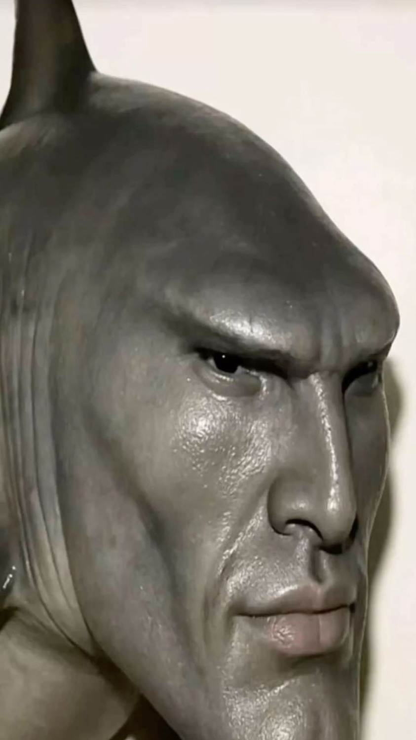Grey shark-headed humanoid statue with a chiseled chad profile