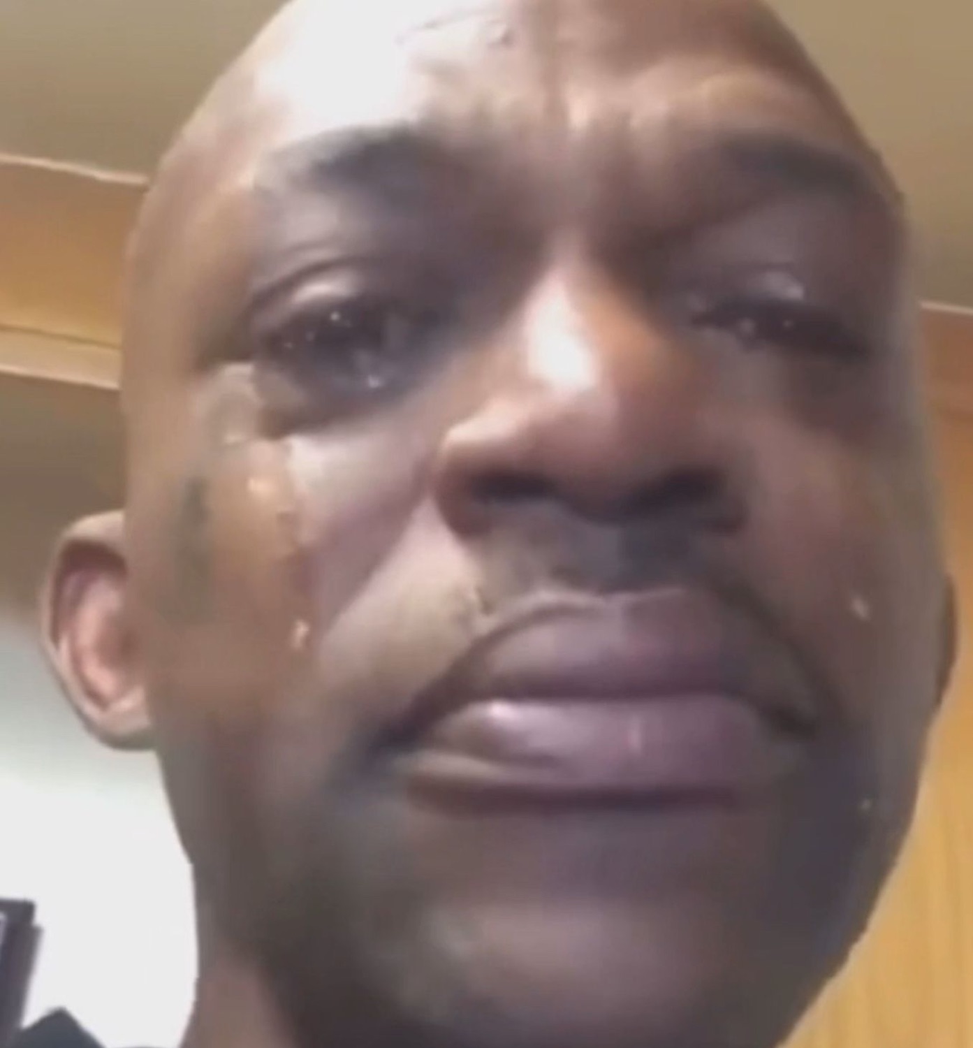Man with tears streaming down his face in a raw, emotional close-up