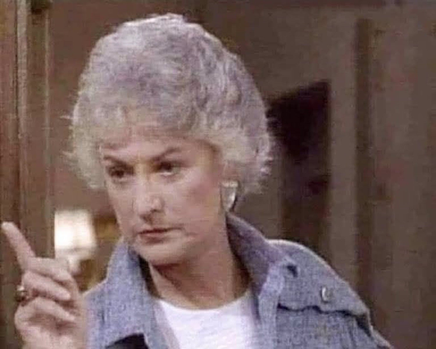 Bea Arthur as Dorothy from The Golden Girls raising a finger with a stern, unimpressed look