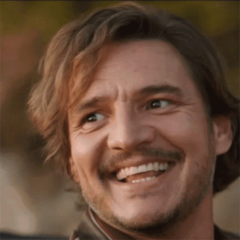 Pedro Pascal laughing with a big warm smile