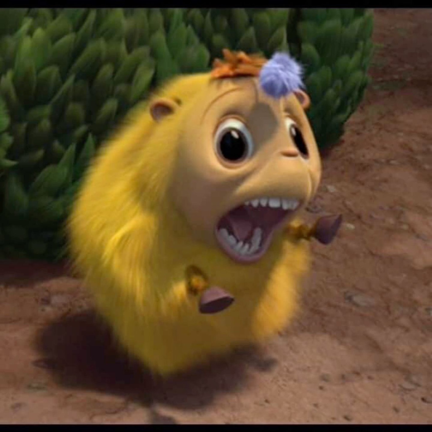 Tiny yellow furry animated creature screaming with its mouth wide open in alarm
