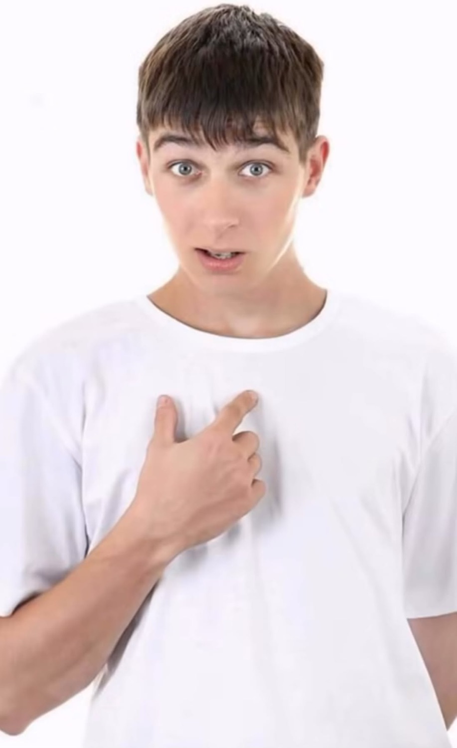 Young man with a hand on his chest looking surprised