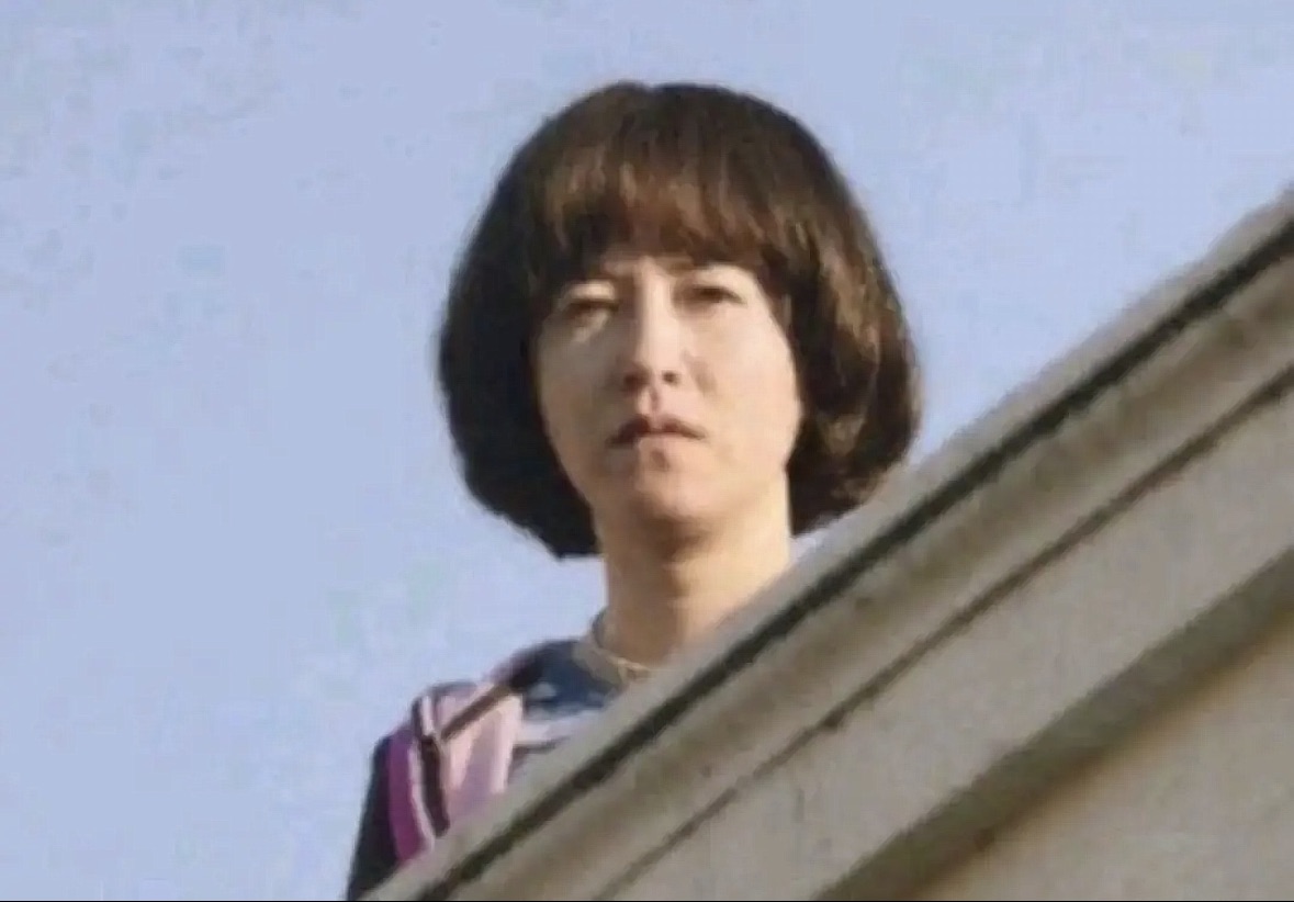Staring from behind asian lady with bowl cut