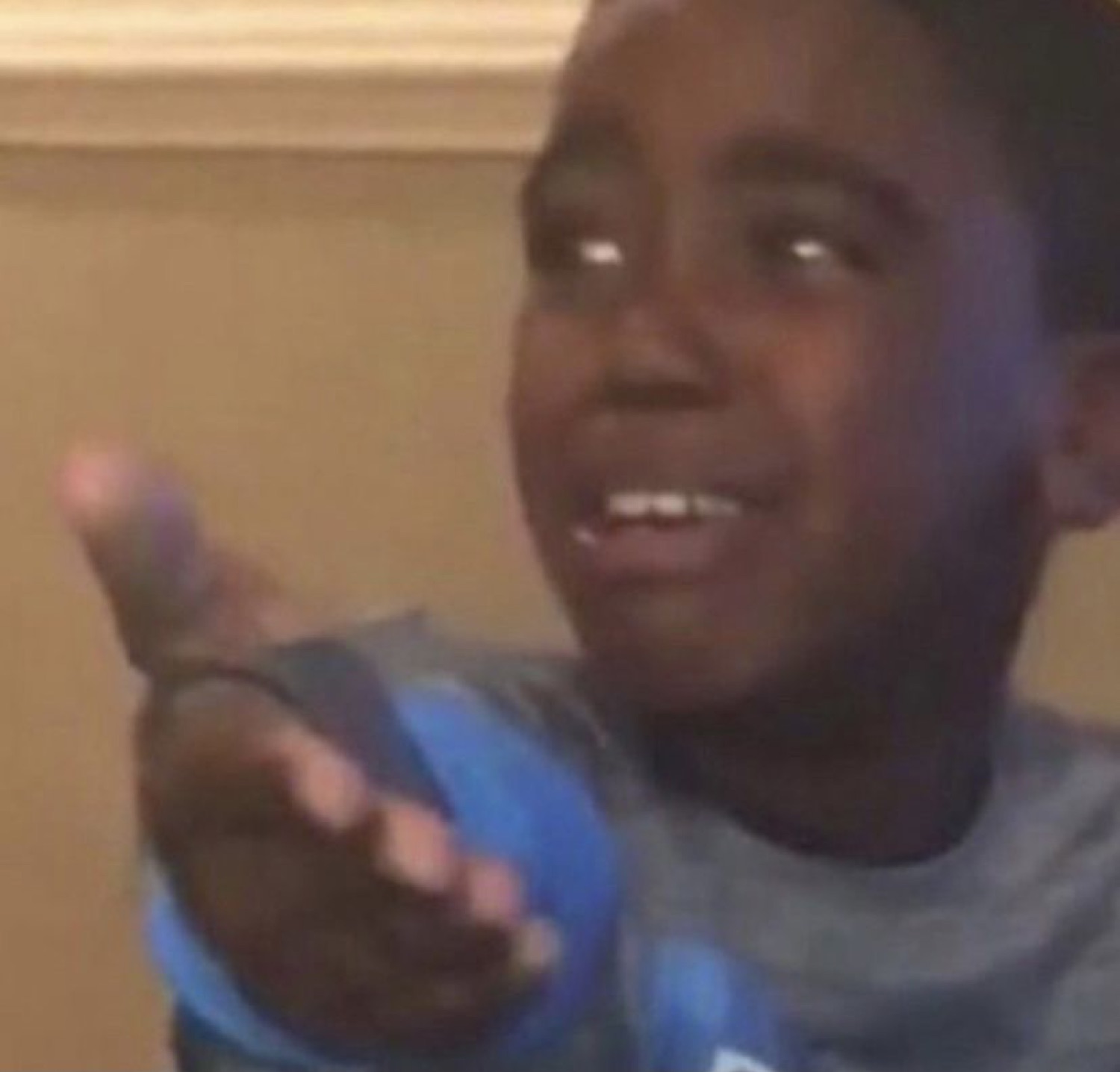 Young boy mid-rant, hand out and face crumpled in emotional protest