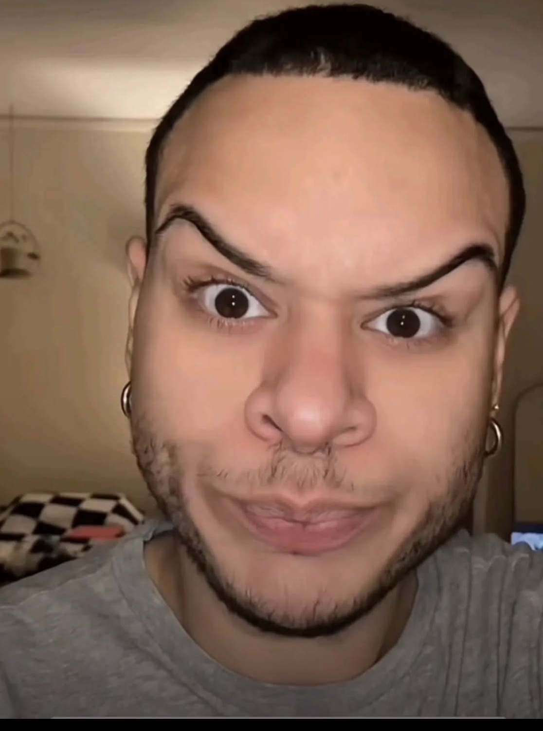 Man with raised eyebrows and a skeptical pout