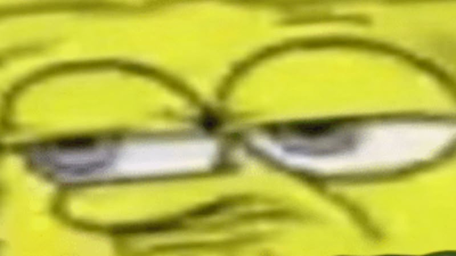 Extreme close-up of SpongeBob squinting with a skeptical frown