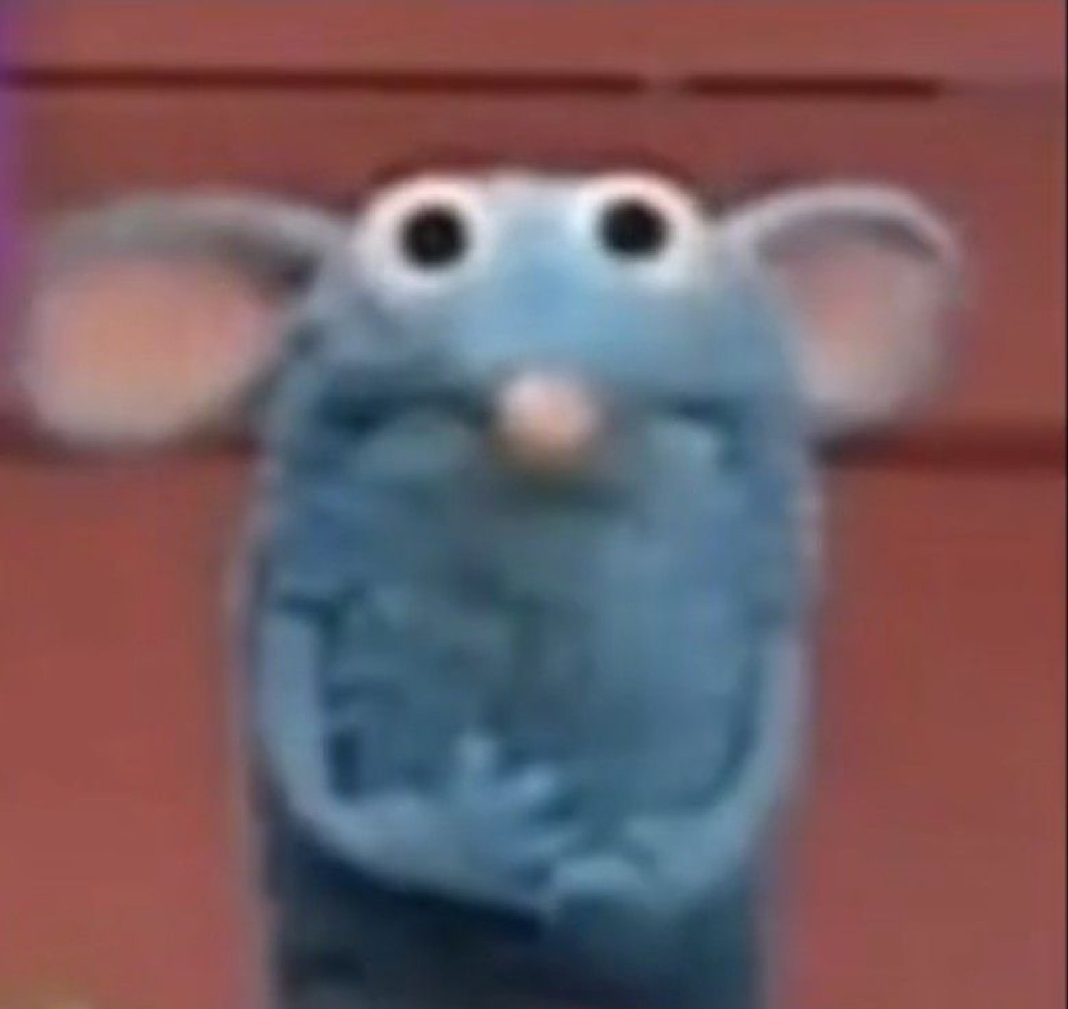Remy from Ratatouille staring forward with wide, startled eyes