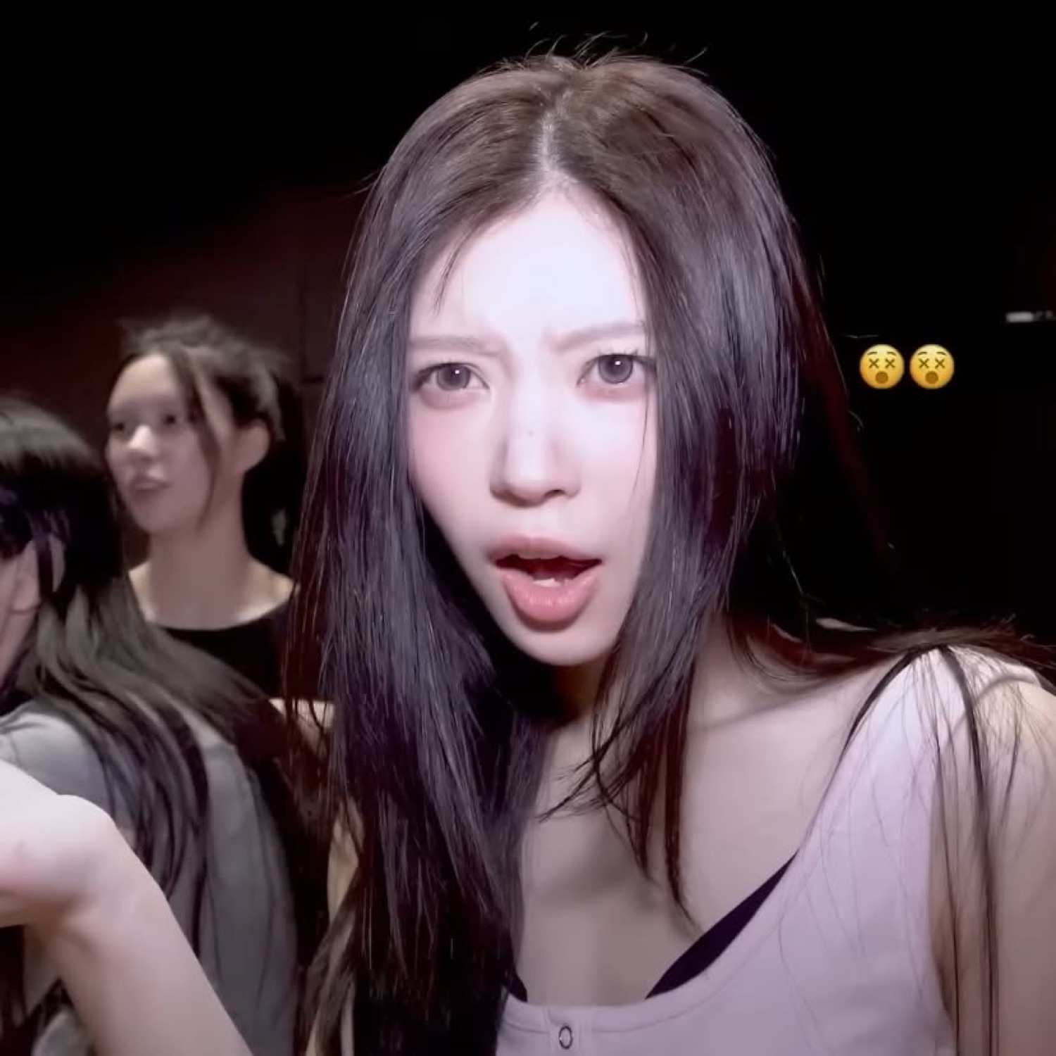 Girl backstage with her jaw dropped, stunned, with dizzy-face emojis beside her