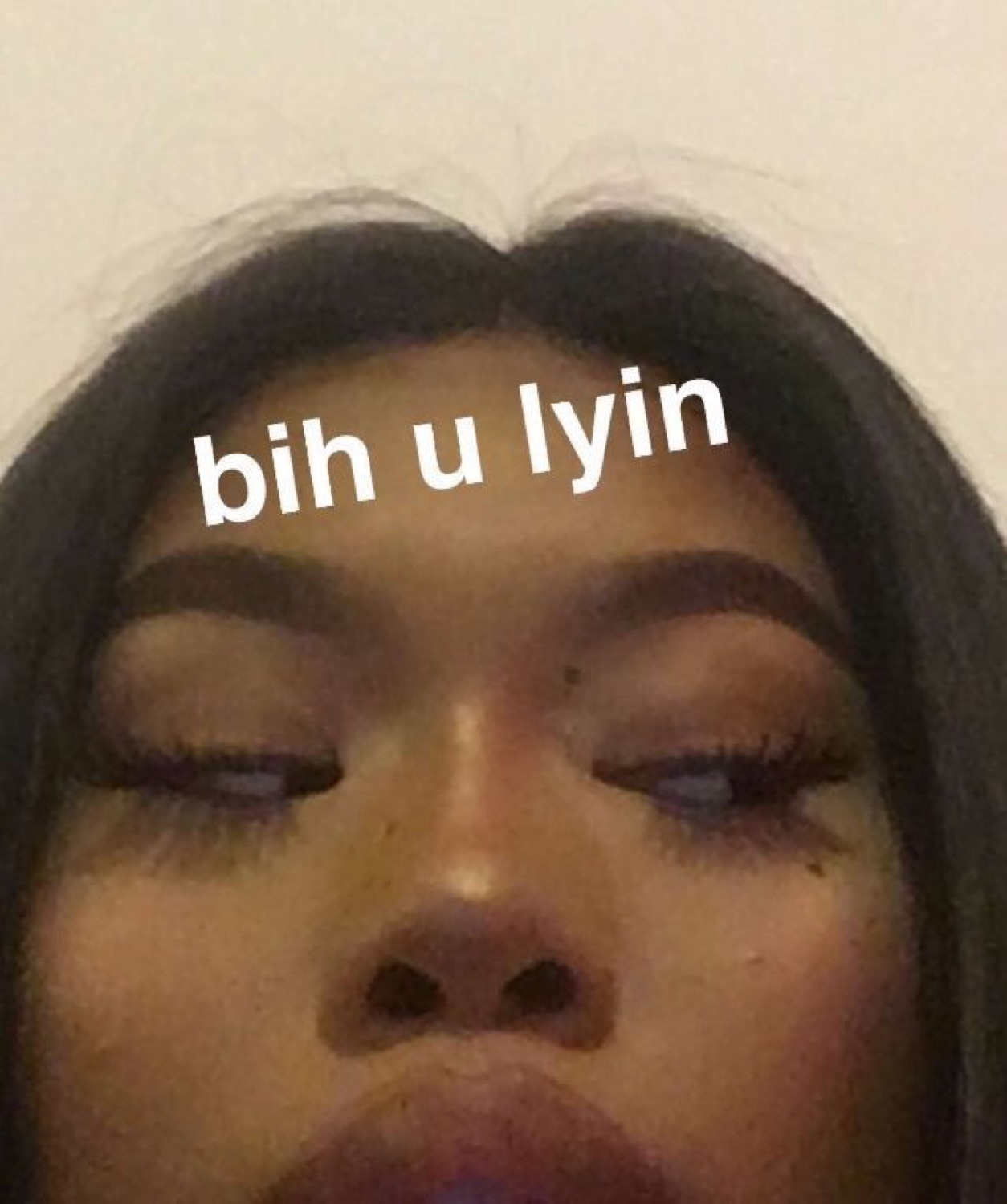 Close-up of a face with eyes half-lowered in disbelief and the caption 'bih u lyin'