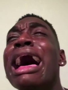 Man ugly-crying with his mouth wide open and tears on his sweaty face