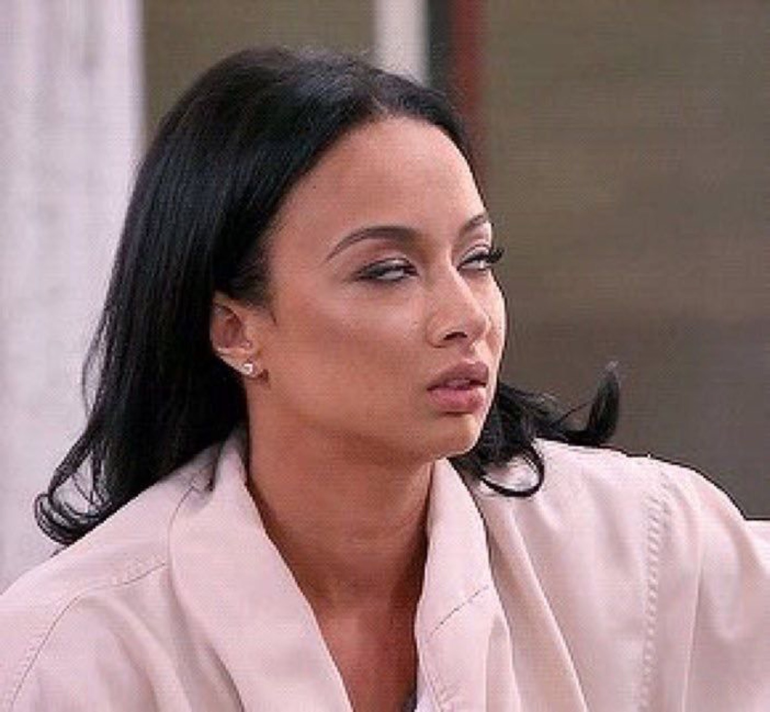 Woman looking off to the side with a tired, unimpressed and over-it expression
