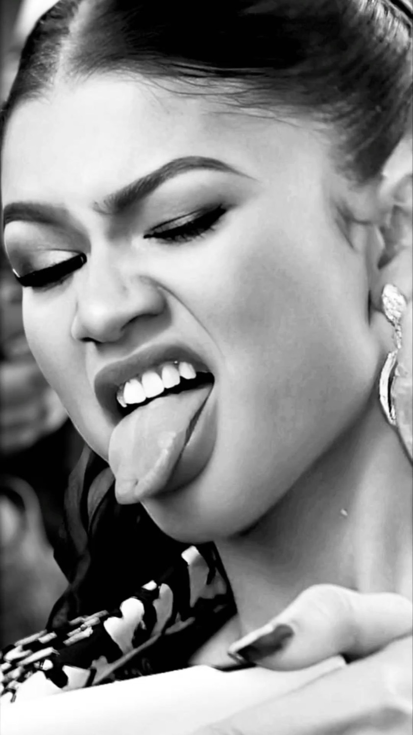 Zendaya in black and white with tongue out and intense eyes, full drama