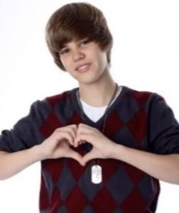 Young Justin Bieber making a heart with his hands