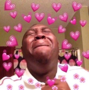 Man overcome with emotion surrounded by a flood of pink heart emojis