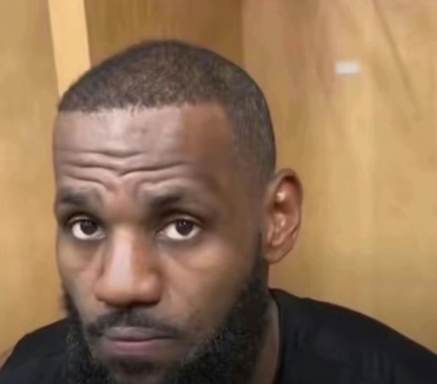 LeBron James staring straight into the camera with a flat, completely blank expression