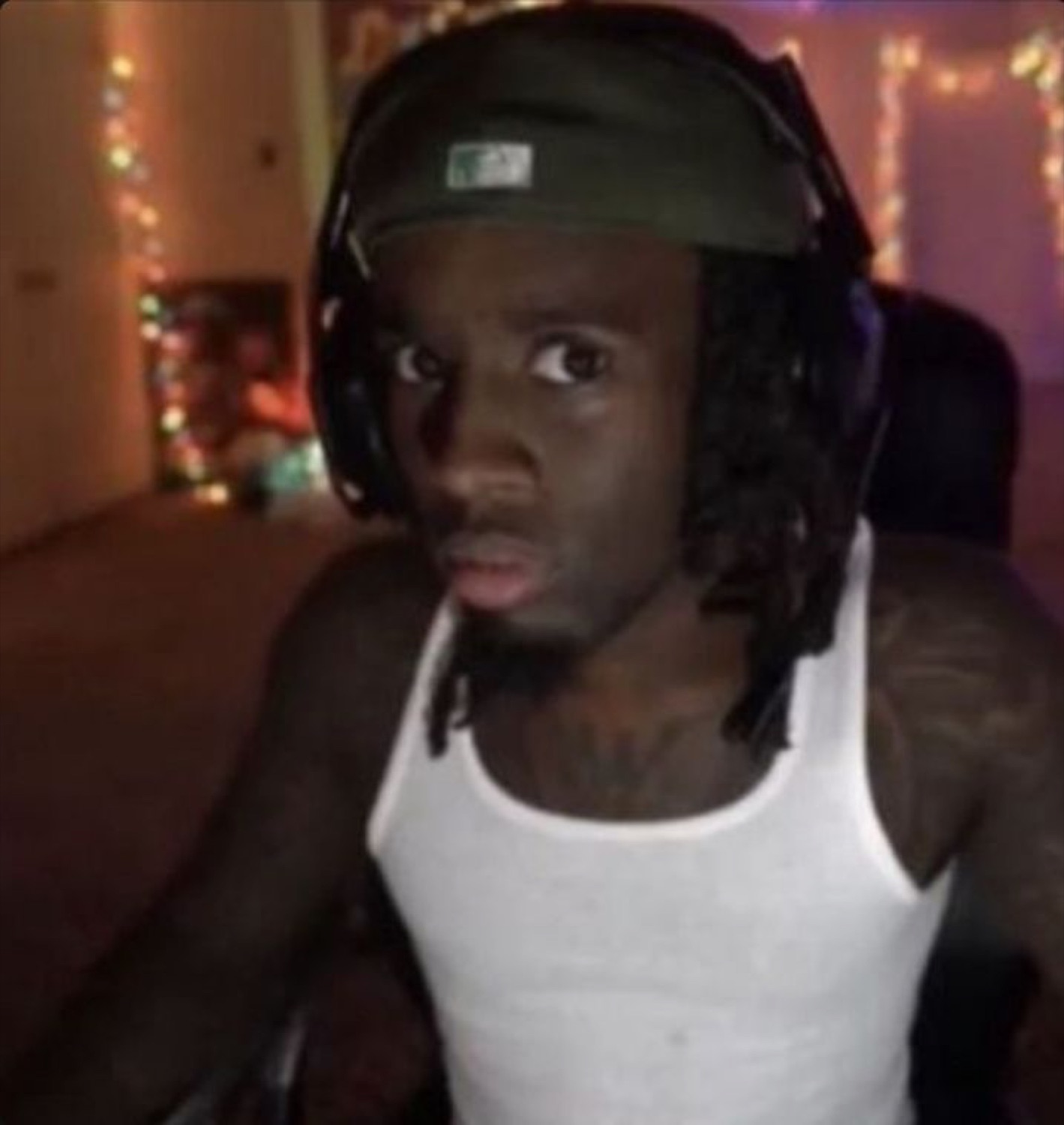 Streamer in a headset and tank top staring at the screen, stunned and lost